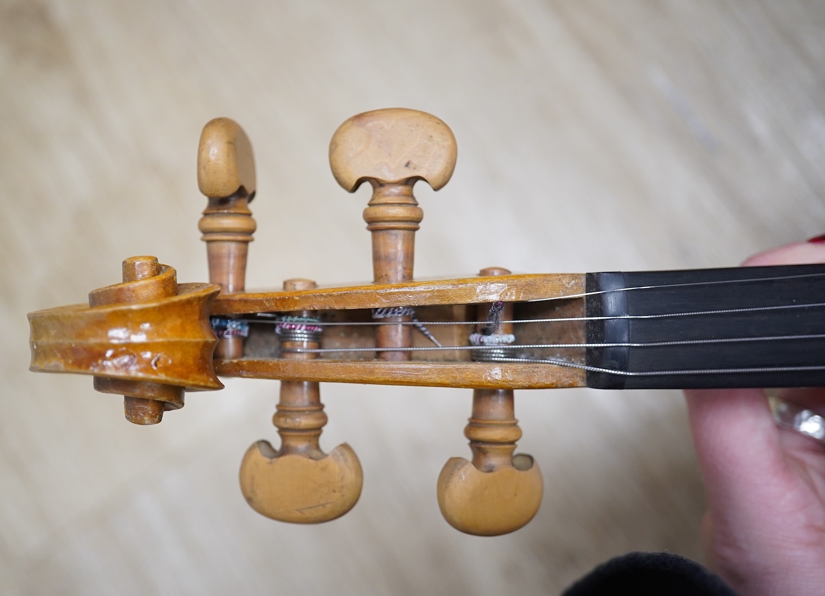 Two cased three quarter size violins, one labelled the London violin Co Ltd, length of back 33.5cm. Condition - both scratched